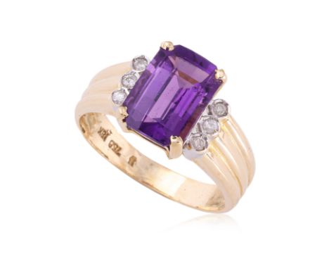 AN AMETHYST GOLD AND DIAMOND RING
Featuring a checkerboard step cut amethyst weighing approximately 2.50 Cts, mounted in a tw