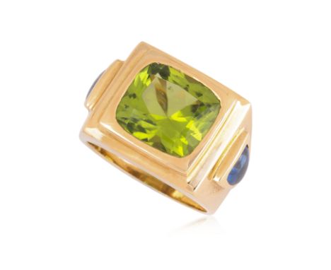 A PERIDOT AND SAPPHIRE RING
Featuring a cushion cut peridot weighing approximately 5.99 Cts (marked), mounted in a yellow gol