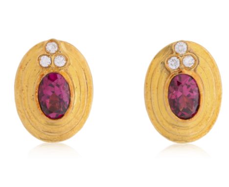 A PAIR OF GARNET AND DIAMOND STUD EARRINGS
Featuring a pair of oval rhodolite garnets totalling approximately 1.60 Cts, mount
