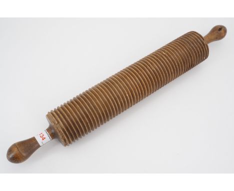 A 19th Century turned beech wood oatmeal rolling pin, 50 cm