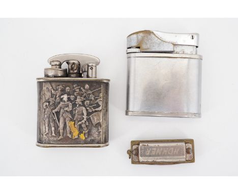 A Hohner miniature harmonica, a Colibri "Rembrandt's The Night Watch" cigarette lighter and one other vintage lighter