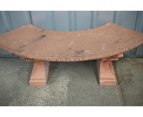 A pre-cast semi-circular garden bench