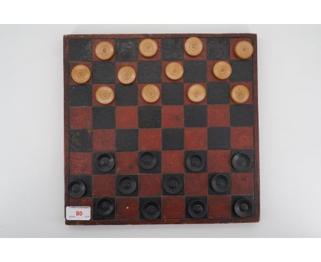 A Vintage turned wooden draughts set and board.