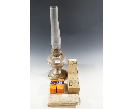 A brass oil lamp, boxed lamp chimney, wicks etc.