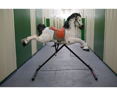 A vintage pressed-steel rocking horse