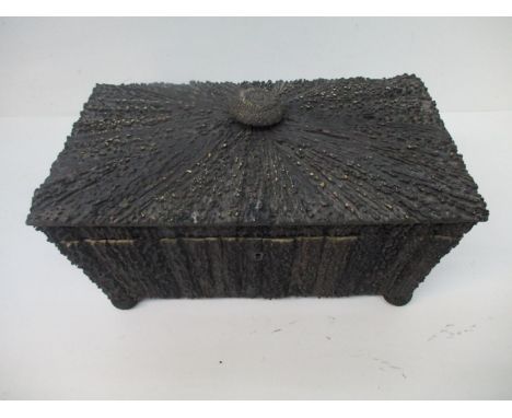 A 19th century horn covered tea caddy of sarcophagus form, with a carved finial and hinged lid, enclosing, twin removable lid
