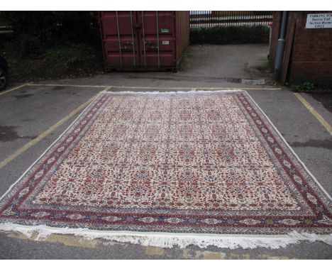 A Turkish Hereke carpet of repeated panels of flowers, palmets, flowering vines and foliage, 188" x 141" 