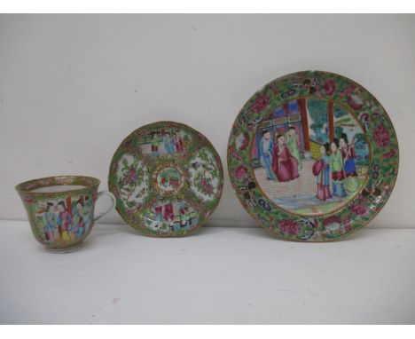 A 19th century Chinese Canton cup and saucer decorated with panels of figures, birds, flowers and foliage and a similar plate