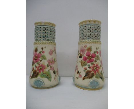 A pair of Zsolnay Pecs vases with cylindrical pierced, reticulated necks and flared body decorated with flowers in pink, gree