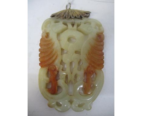 A late 19th/early 20th century two tone, brown jade pendant carved and pierced with two birds, on a gilt filigree suspension 