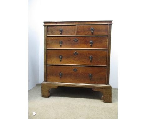 An 18th century walnut, yew, pitch pine and oak chest of two short and three graduated long drawers, with an oyster veneered 