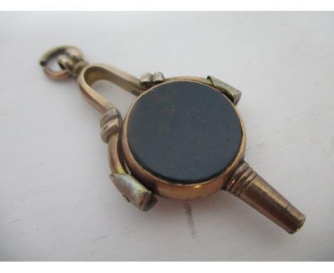 A 9ct gold rotating fob watch key set with two stone tablets, on a frame and suspension ring, 9g total 