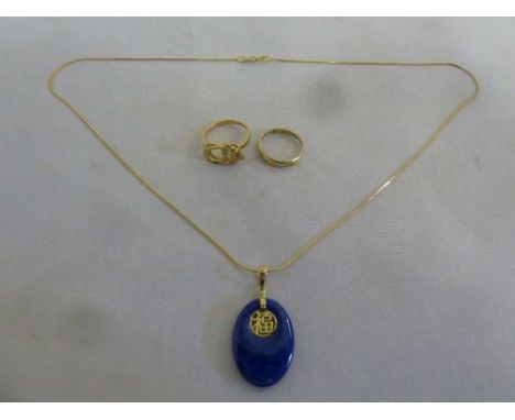 A quantity of gold jewellery to include a Chinese pendant on a chain, a wedding band and a ring, all tested 14ct, approx tota