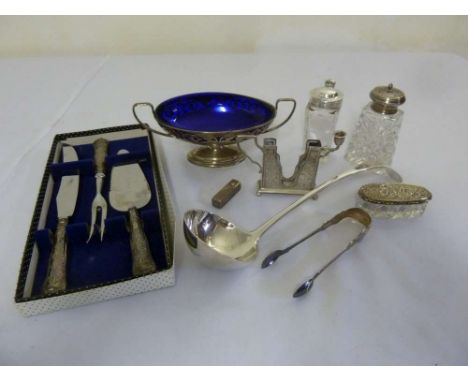 A quantity of silver and white metal to include a ladle, silver bowl with blue glass liner, a pair of tongs and a carving set