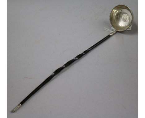 An 18th century white metal toddy ladle, with inset coin bowl and baleen handle, 36.6cm.