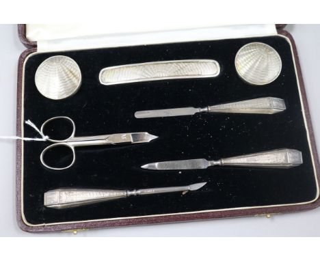 An Adie Bros engine-turned silver manicure set, cased.