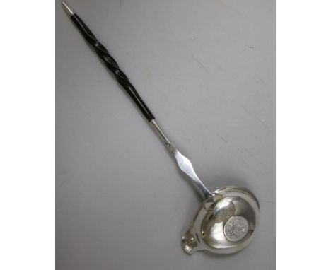 An 18ct century silver toddy ladle with baleen handle and bowl with inset coin, 31.7cm.