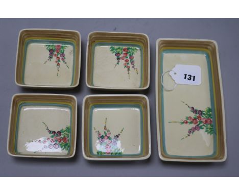 A Clarice Cliff 'Hollyhocks' hors d'oeuvres set, comprising one rectangular dish and four small square dishes (one a.f.)