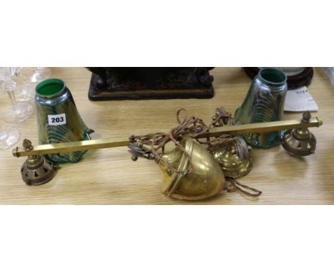 A brass rise and fall lamp with iridescent glass shades