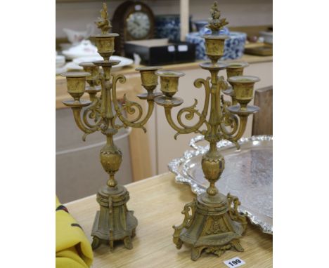 A pair of Victorian gilt metal three branch four light candelabra 40cm.