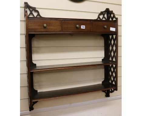 A mahogany wall shelf W.74cm