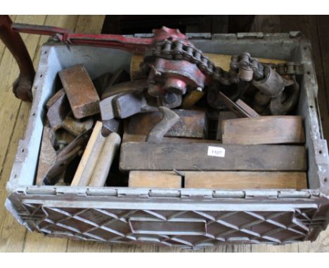 A collection of old wood working tools including planes and timber jack