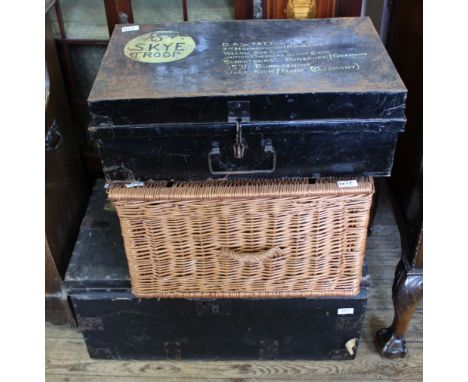 A canvas travelling trunk, wicker hamper and black metal trunk