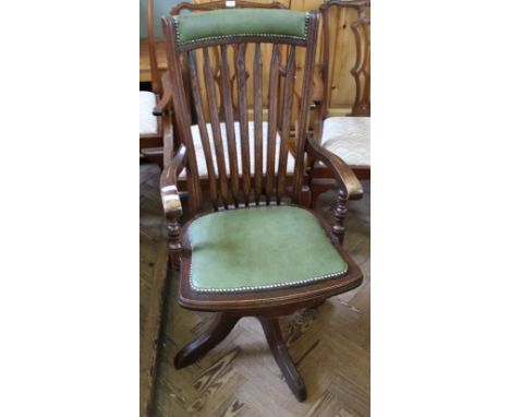 A 1920's oak leather seat and stick back swivel office Captains chair