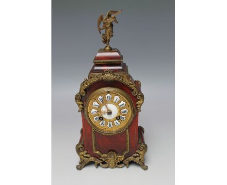 A LATE 19TH / EARLY 20TH CENTURY FRENCH FAUX TORTOISHELL MANTEL CLOCK, gilt metal mounts to the case, mask decoration below t