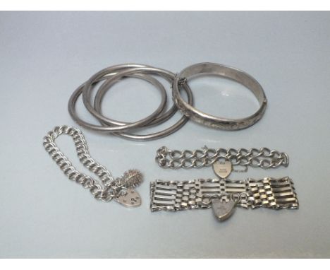 A COLLECTION OF SILVER AND WHITE METAL BRACELETS, to include a silver six bar gate bracelet with hallmarked clasp etc. (6)