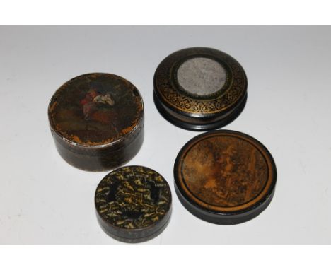 THREE GEORGIAN PAPIER MACHE SNUFF BOXES, of circular form, each with decoration to the lids, together with an Islamic example