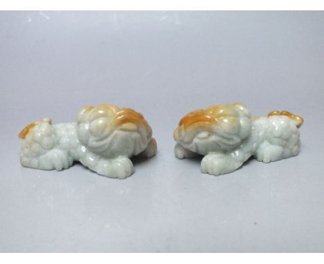 A PAIR OF CARVED JADE TEMPLE DOGS, polished gloss like finish highlighting the natural colour formations within the stone, W 