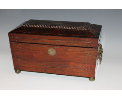 A GEORGIAN ROSEWOOD TEA CADDY WITH BRASS INLAY, brass lion mask handles,  the hinged lid opening to reveal a fitted interior,