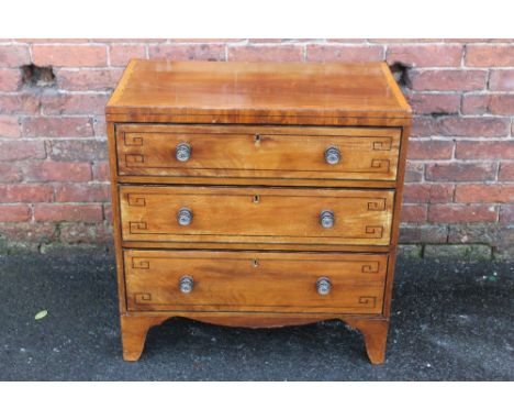 A 19TH CENTURY MAHOGANY CHEST OF SMALL PROPORTIONS, the top with cross banded detail, three long graduated drawers each with 