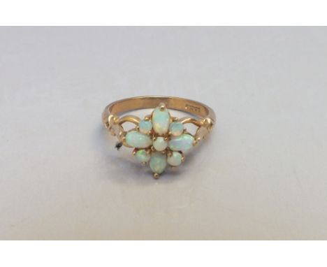 A MODERN 9CT GOLD AND OPAL DRESS RING, floral style claw setting