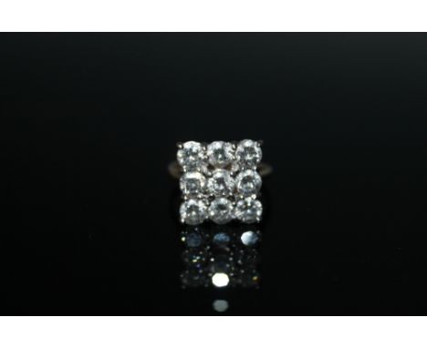 AN 18 CARAT NINE STONE DIAMOND RING, in a square setting with approx total diamond weight of 2.3 carats, ring size K 