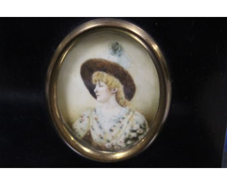 A 19TH CENTURY OVAL MINIATURE PORTRAIT, a classically dressed lady wearing a hat, on ivory, framed, 6 x 4.5 cm