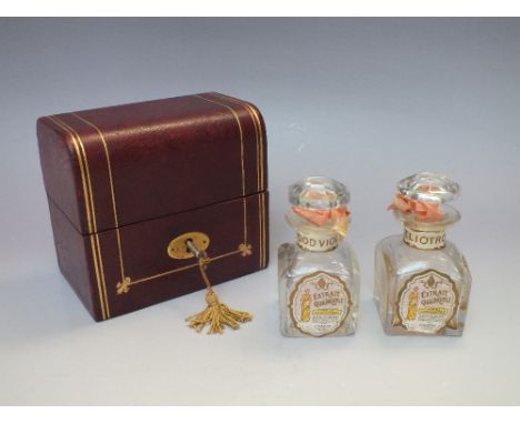 A CASED PERFUME DECANTER SET, the domed leather case with gilt embellishment, stamped Sharp Bros. London, containing two perf