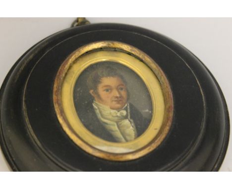 A GEORGIAN LATE 18TH CENTURY OVAL PORTRAIT MINIATURE OF A GENTLEMAN, wearing a striped waistcoat, on tin, framed, 5.5 x 4 cm
