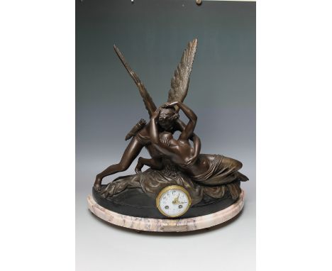 AN EARLY 20TH CENTURY SPELTER MANTEL CLOCK DEPICTING 'CUPID AND PSYCHE',  eight day movement striking on a bell, circular ena