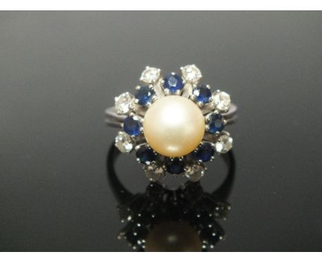 A DIAMOND SAPPHIRE AND PEARL RING, the central pearl measuring approx 8.9 mm is surrounded by eight brilliant cut sapphires t