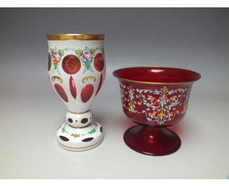 A BOHEMIAN WHITE OVERLAY CRANBERRY GLASS GOBLET, with hand painted floral and gilt enamel decoration, H 17.2 cm, together wit