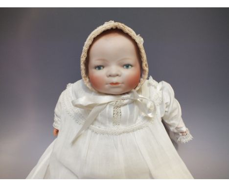 A VINTAGE BYE-LO BISQUE HEADED DOLL, designed by Grace Putnam, impressed marks to the neck, sleeping eyes,cloth body with com