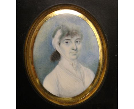 A GEORGIAN OVAL PORTRAIT MINIATURE, depicting a lady wearing a white dress, on ivory, framed, 7 x 5.5 cm