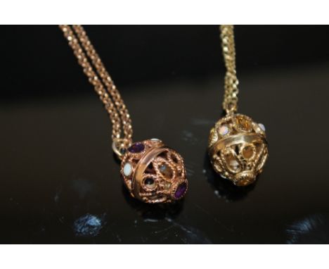 TWO JEWELLED CAGE PENDANTS, one in yellow gold, the other in rose gold, the yellow gold is set with citrine and opal type sto