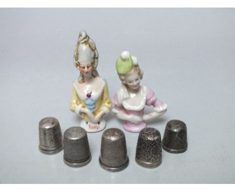 TWO CERAMIC PIN CUSHION DOLLS, tallest H 6.5 cm, together with a selection of thimbles to include hallmarked silver examples