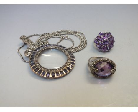 A SILVER MARCASITE AND AMETHYST PENDANT MAGNIFYING GLASS, pendants drop 7.5 cm, suspended from a fine silver chain, together 