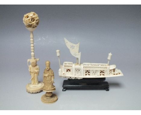 AN ANTIQUE IVORY CARVED PUZZLE BALL AND STAND, overall H 16 cm, together with a carved figural chess piece and a carved model