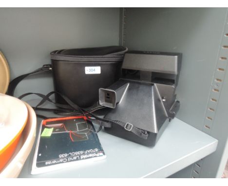 A polaroid super colour 635 camera in original case