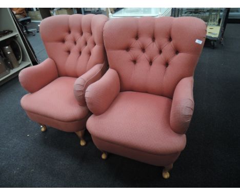 A pair of button back arm chairs